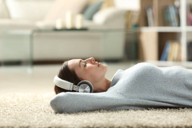 Woman lying down and listening to music